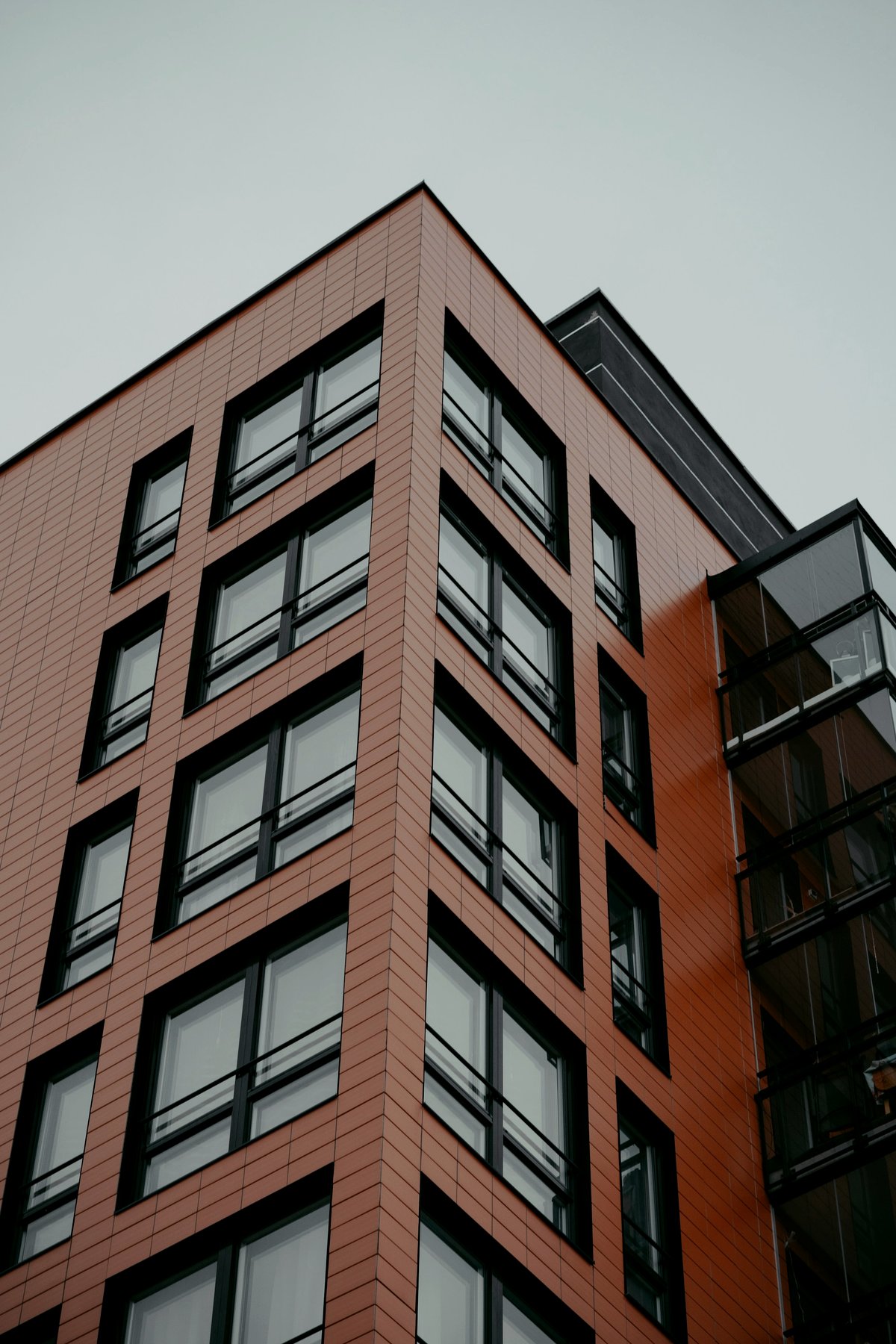 A modern brick apartment building against the sky
